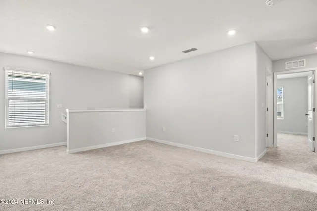an empty room with windows and closet