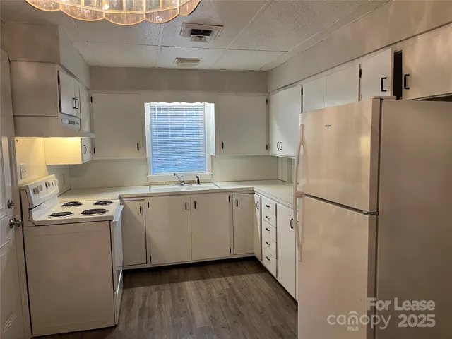 a white refrigerator freezer sitting inside of a kitchen