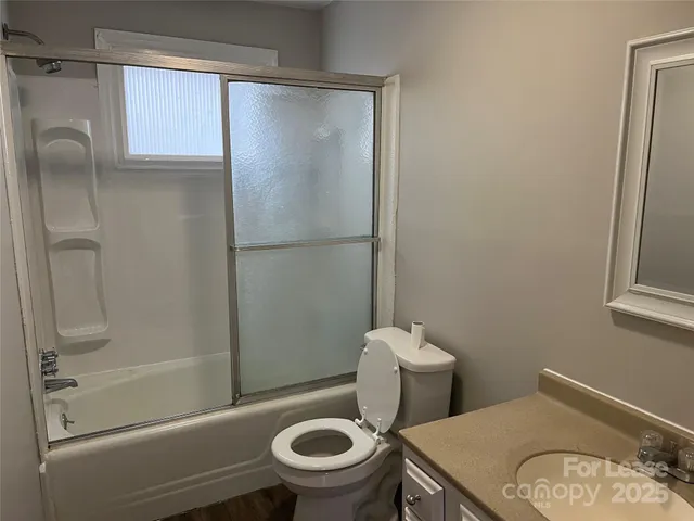 a white toilet sitting next to a bath tub