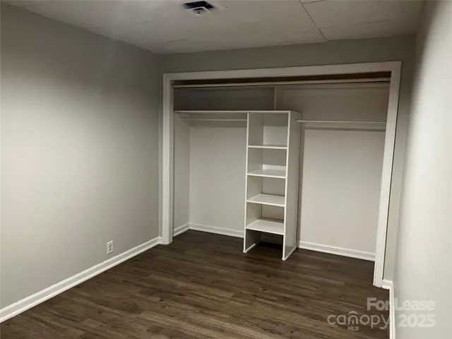 a view of walk in closet with empty racks