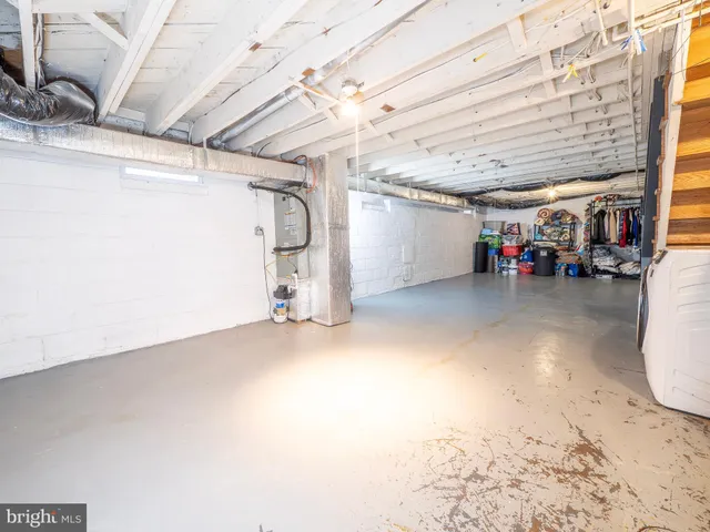 a view of a big room with air conditioner duct and materials on floor