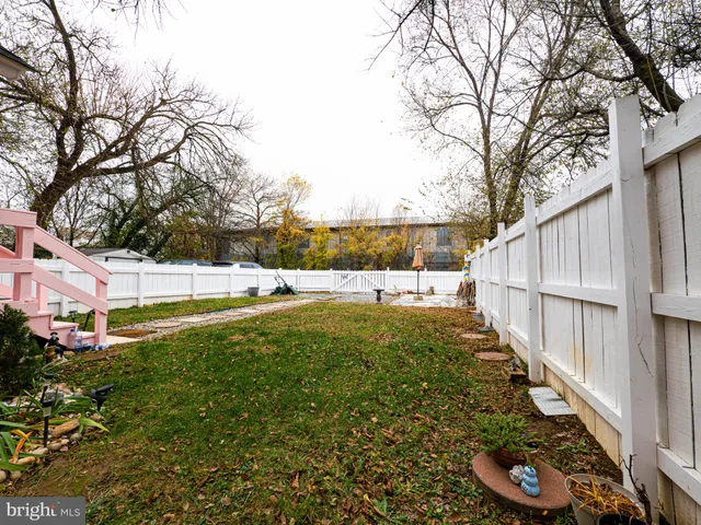 a view of a backyard with large trees