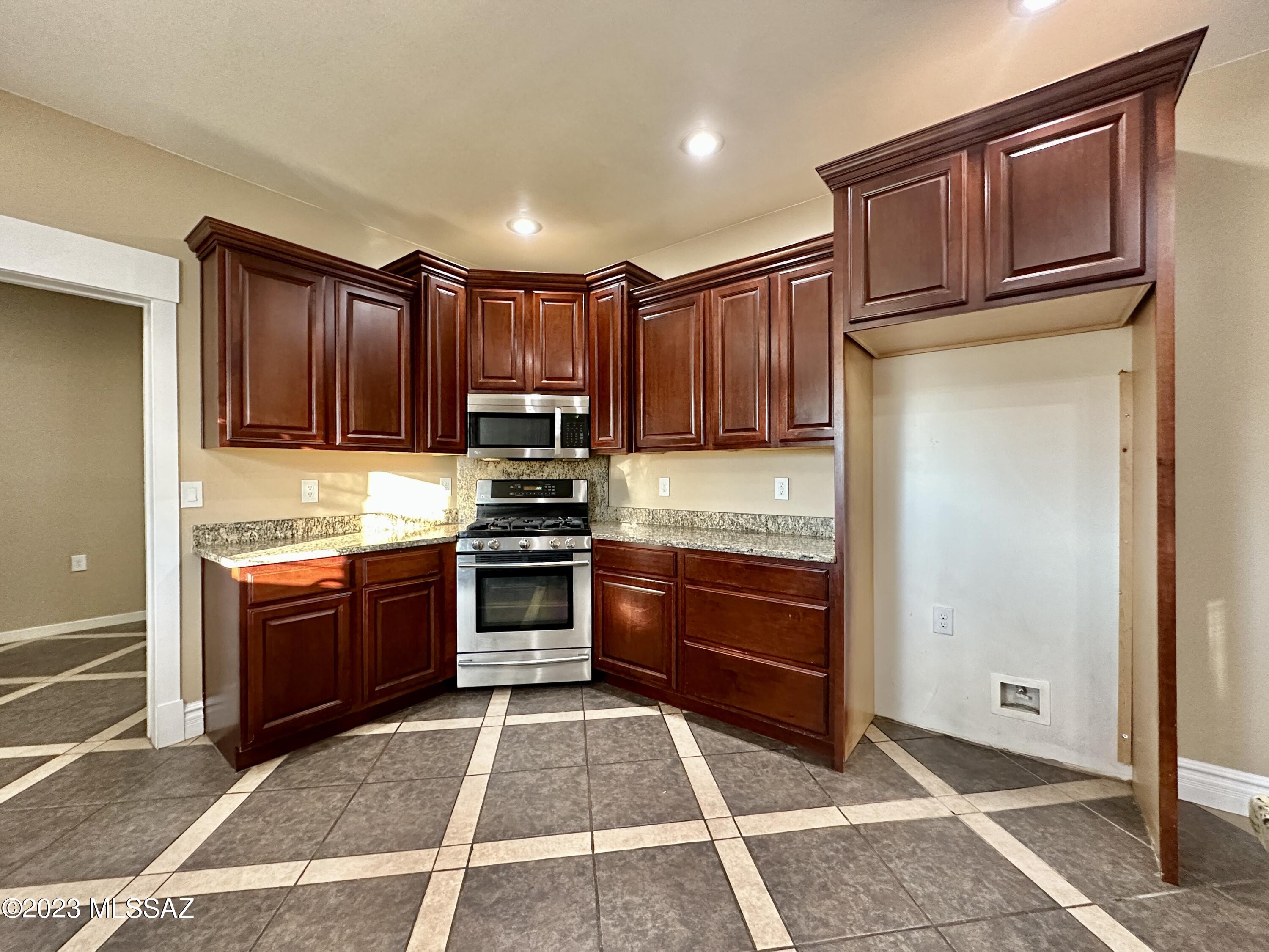 508 Eagle Meadow Loop Thatcher, AZ 85552 - Photo 4 of 32 a kitchen with stainless steel appliances granite countertop a refrigerator stove top oven and sink