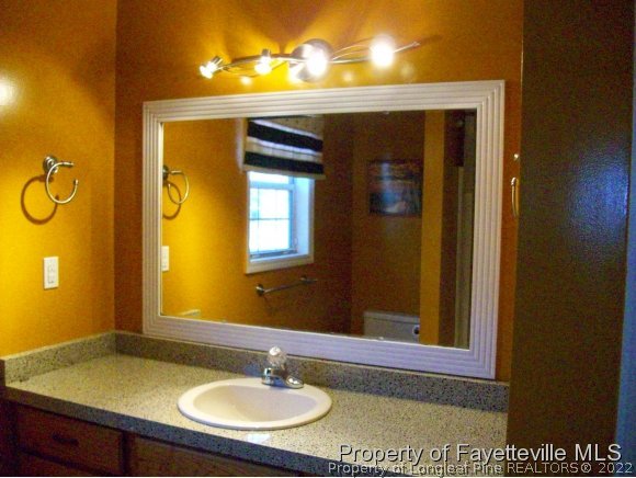 8716 Godwin-Falcon Road Godwin, NC 28344 - Photo 11 of 25 a bathroom with a sink and a mirror