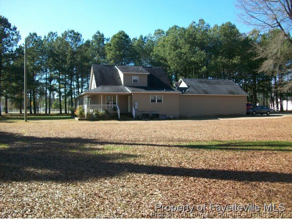 8716 Godwin-Falcon Road Godwin, NC 28344 - Photo 15 of 25 a front view of a house with a yard
