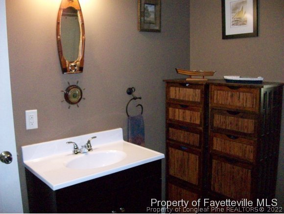 8716 Godwin-Falcon Road Godwin, NC 28344 - Photo 21 of 25 a bathroom with a sink and a mirror