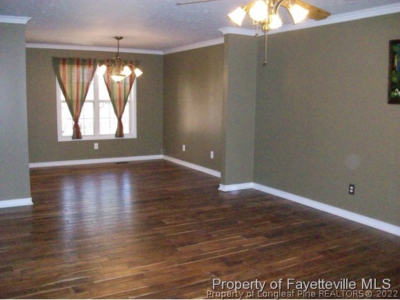 8716 Godwin-Falcon Road Godwin, NC 28344 - Photo 4 of 25 an empty room with wooden floor and windows