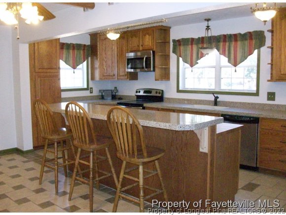 8716 Godwin-Falcon Road Godwin, NC 28344 - Photo 7 of 25 a view of a kitchen with granite countertop a sink and a counter top space