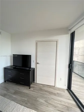 a bedroom with two beds and a window