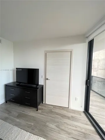 a bedroom with two beds and a window