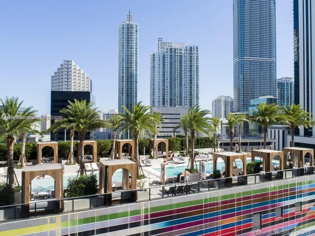 a front view of a multi story residential apartment building with yard