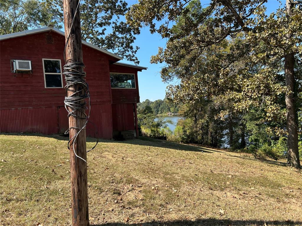 401 Ridge Row Many, LA 71449 - Photo 15 of 17 View of home's exterior featuring a lawn and a water view
