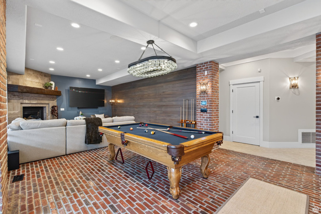 12308 Mariah Circle Draper, UT 84020 - Photo 97 of 293 Recreation room featuring a pool table, brick-finish flooring, and a stone-clad fireplace with a wood mantle