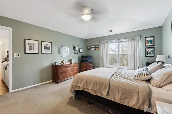 a bedroom with a bed and a dresser with kitchen