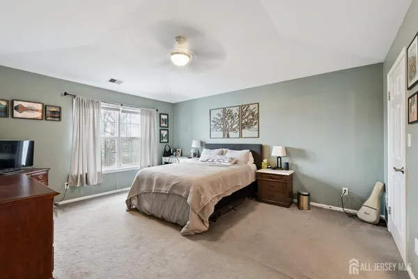 a spacious bedroom with a bed and a couch