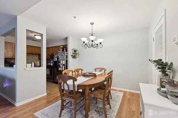 a dining room with furniture potted plants and wooden floor