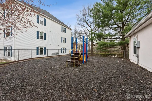 a view of a house with backyard and a tree