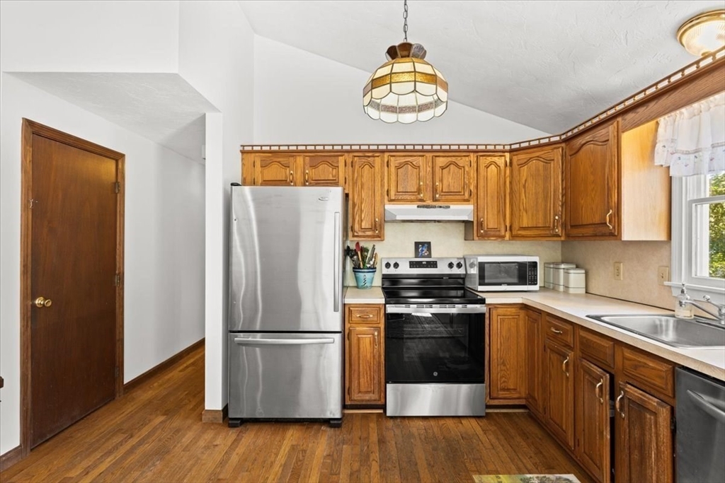 83 Red Brook Road Wareham, MA 02532 - Photo 12 of 36 a kitchen with a refrigerator a stove a sink and a window