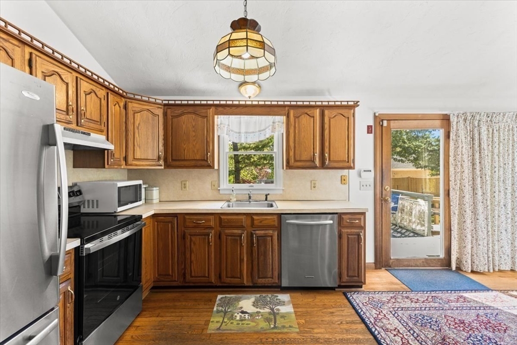 83 Red Brook Road Wareham, MA 02532 - Photo 13 of 36 a kitchen with stainless steel appliances granite countertop a stove a sink and a refrigerator