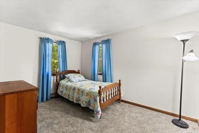a bed sitting in a bedroom next to a cabinet