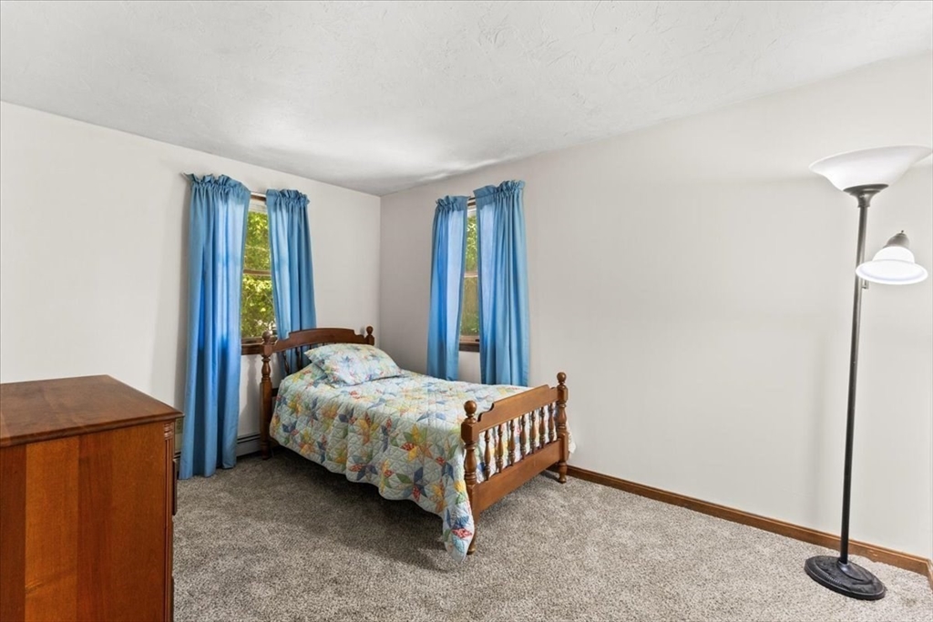 83 Red Brook Road Wareham, MA 02532 - Photo 17 of 36 a bed sitting in a bedroom next to a cabinet