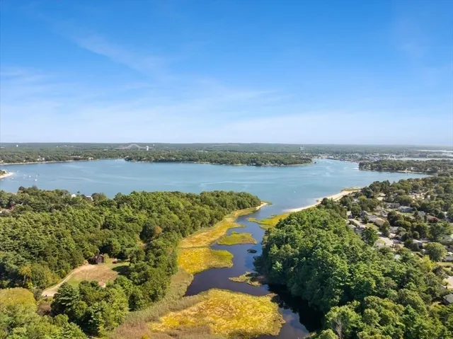 a view of a lake with houses in the back