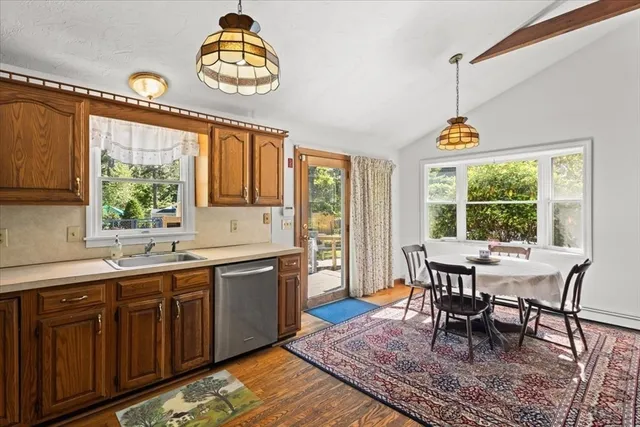 a dining hall with granite countertop a dining table and chairs with the wooden floor