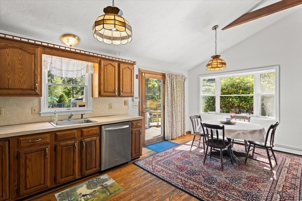 83 Red Brook Road Wareham, MA 02532 - Photo 8 of 36 a dining hall with granite countertop a dining table and chairs with the wooden floor