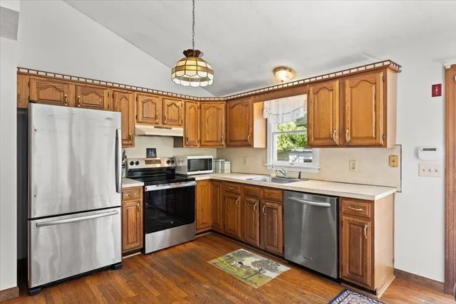 a kitchen with a refrigerator and a sink