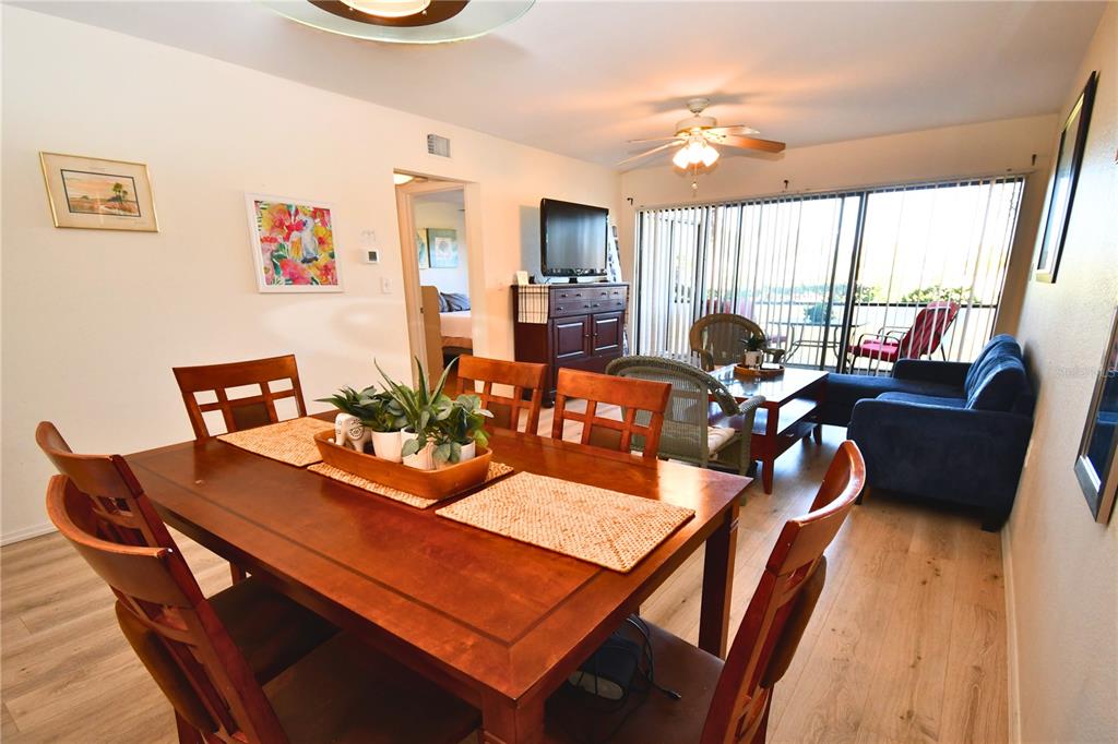 a view of a dining room with furniture a rug and a large window