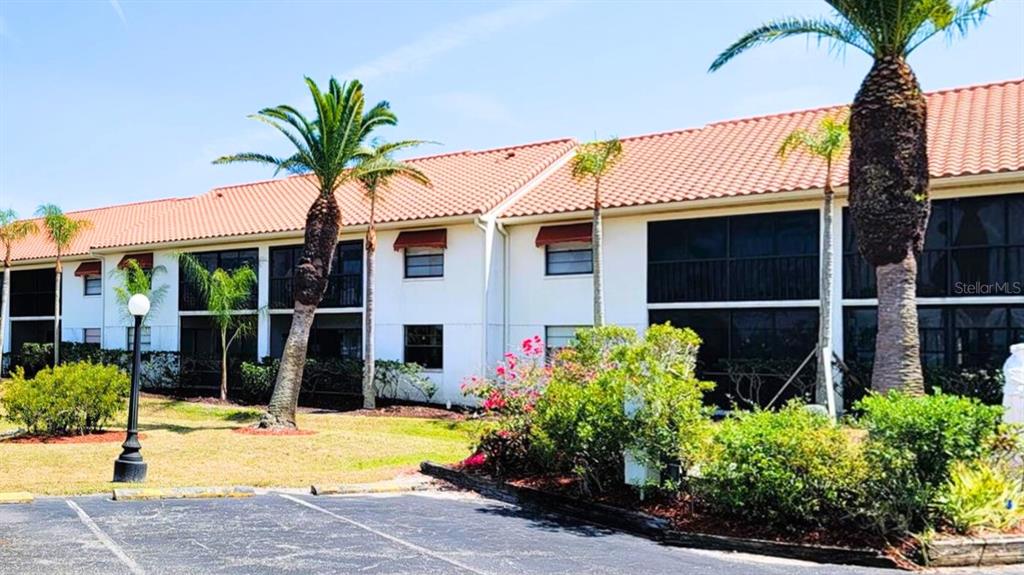 2275 South McCall Road, Unit 103 Englewood, FL 34224 - Photo 16 of 17 a front view of a house with garden