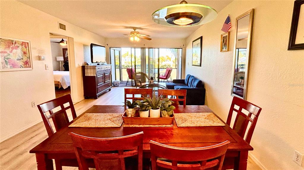 2275 South McCall Road, Unit 103 Englewood, FL 34224 - Photo 2 of 17 a dining room with furniture a rug and a large window