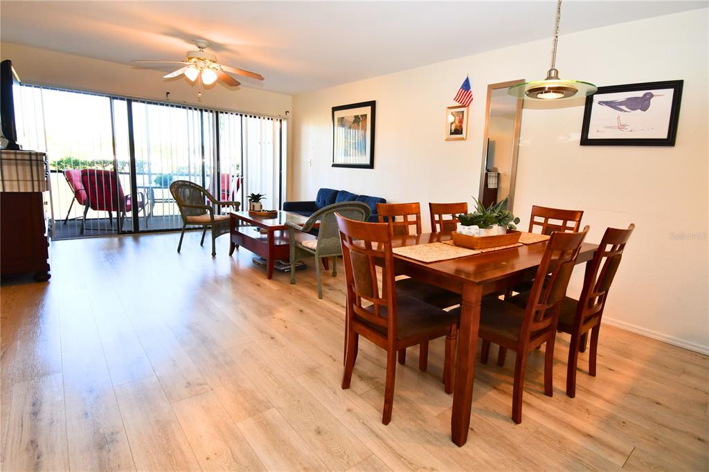 2275 South McCall Road, Unit 103 Englewood, FL 34224 - Photo 4 of 17 a view of a dining room with furniture window and wooden floor