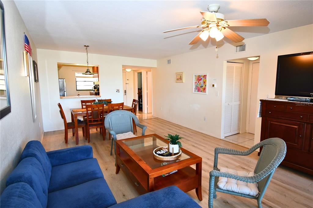 2275 South McCall Road, Unit 103 Englewood, FL 34224 - Photo 5 of 17 a living room with furniture and a flat screen tv