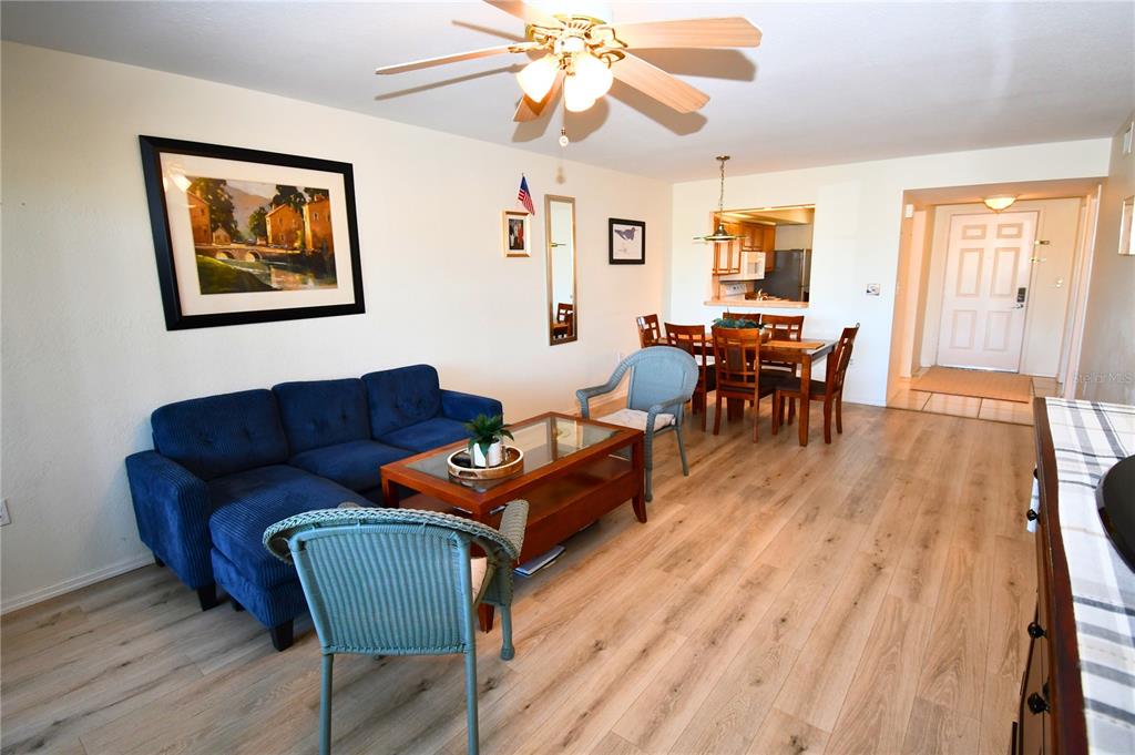 2275 South McCall Road, Unit 103 Englewood, FL 34224 - Photo 6 of 17 a living room with furniture a wooden floor and a window