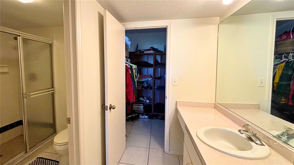 2275 South McCall Road, Unit 103 Englewood, FL 34224 - Photo 8 of 17 a en suite bathroom with a sink and a mirror