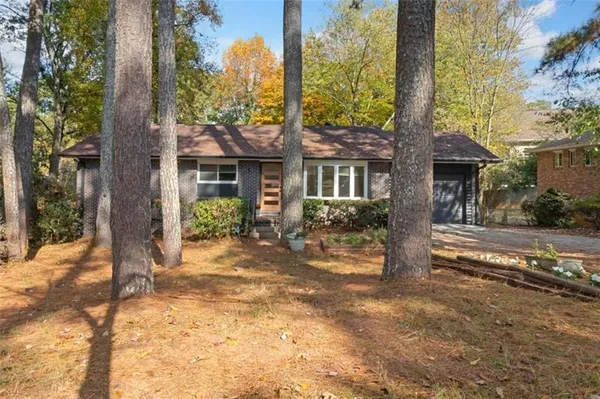a view of a house with a tree in the background