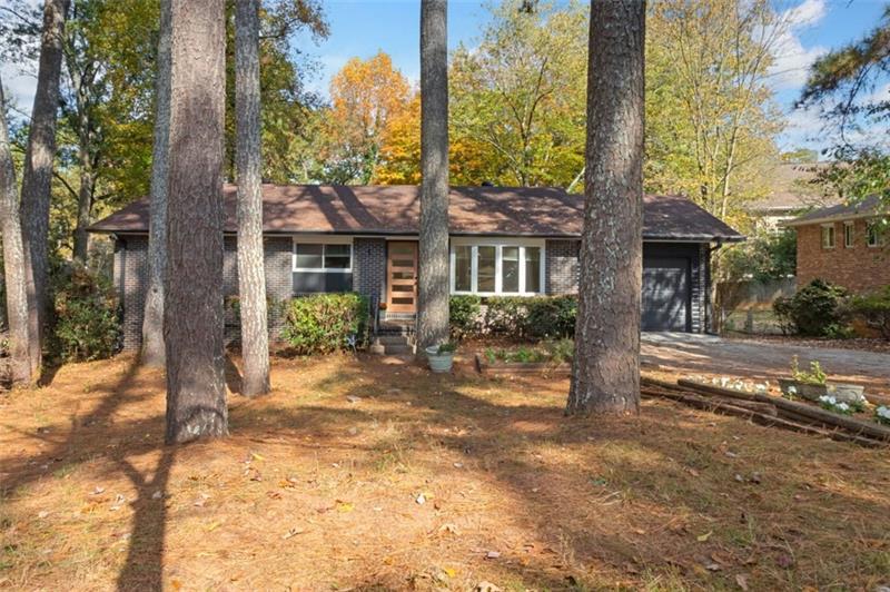 a view of a house with a tree in the background
