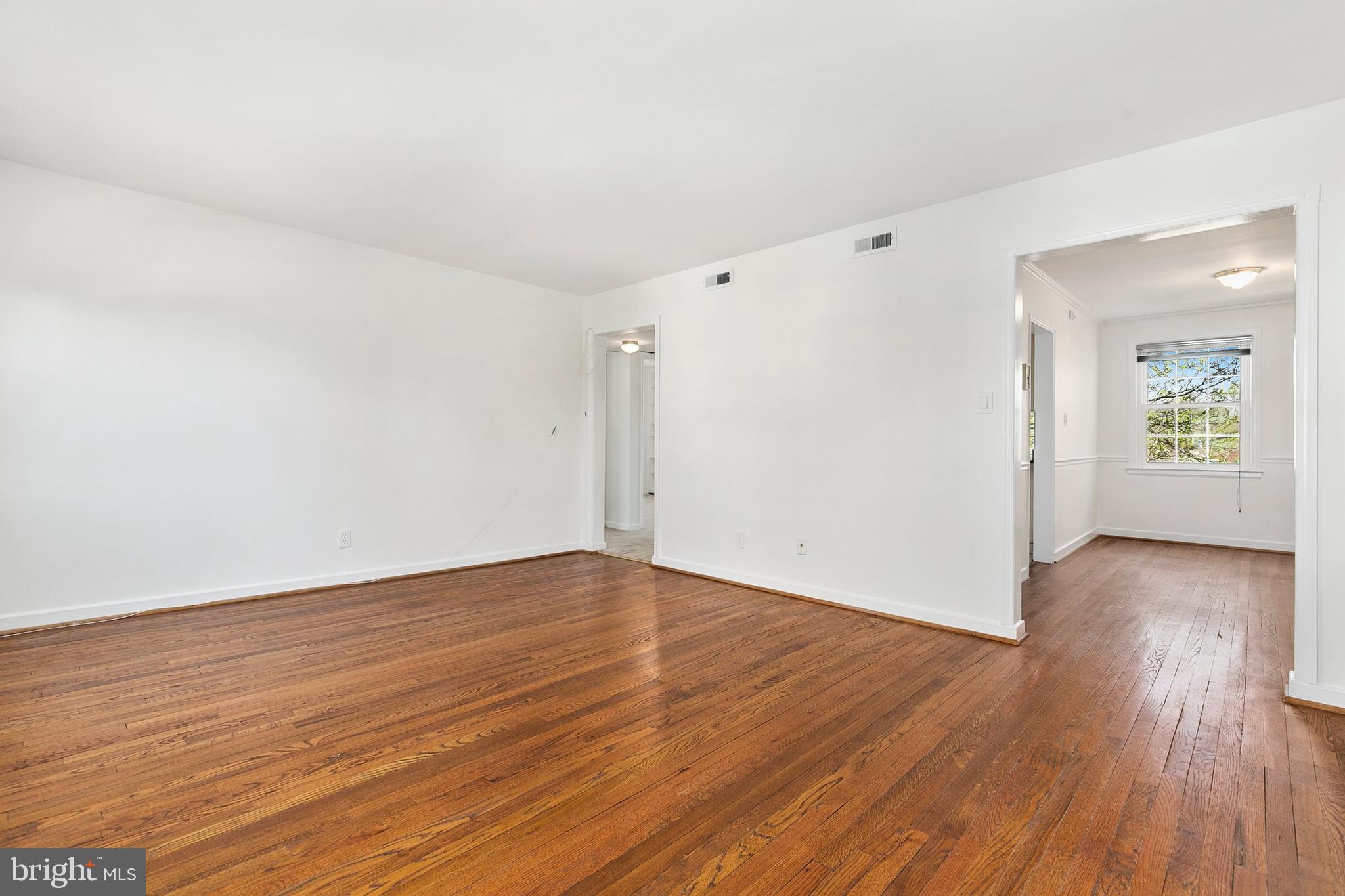 2211 Washington Avenue, Unit 303 Silver Spring, MD 20910 - Photo 16 of 28 a view of an empty room with wooden floor and a window