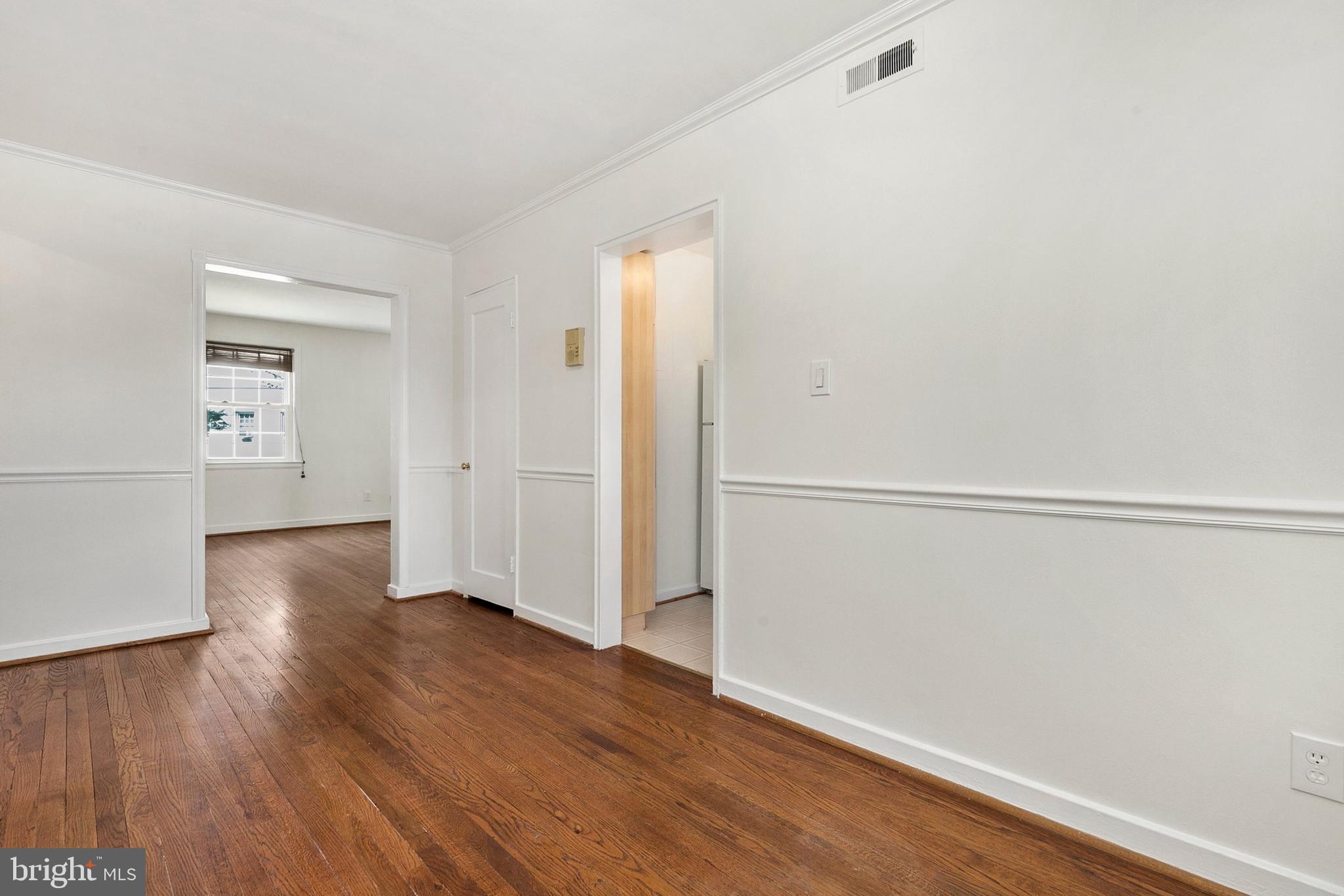 2211 Washington Avenue, Unit 303 Silver Spring, MD 20910 - Photo 20 of 28 an empty room with wooden floor