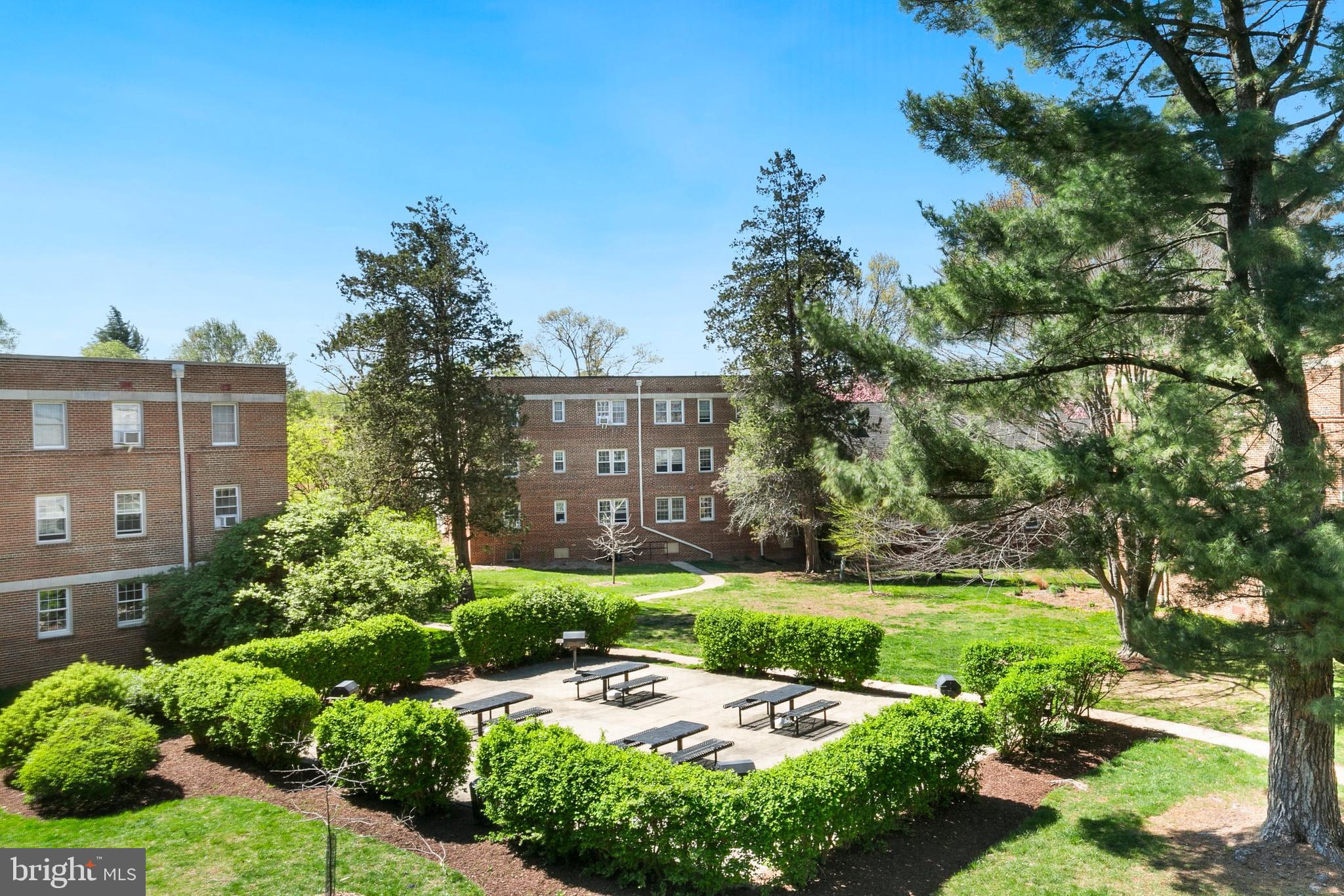 2211 Washington Avenue, Unit 303 Silver Spring, MD 20910 - Photo 27 of 28 a view of a garden with a building in the background