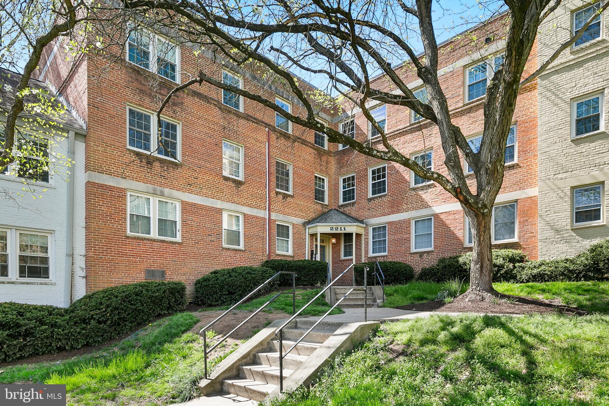 2211 Washington Avenue, Unit 303 Silver Spring, MD 20910 - Photo 3 of 28 a front view of a house with a yard and outdoor seating
