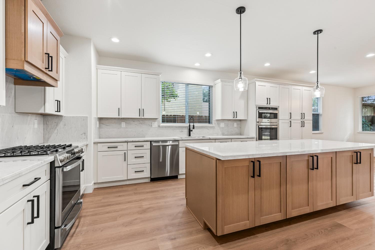 688 Cindy Drive Ripon, CA 95366 - Photo 12 of 57 a kitchen with stainless steel appliances granite countertop a sink a stove and a wooden floors