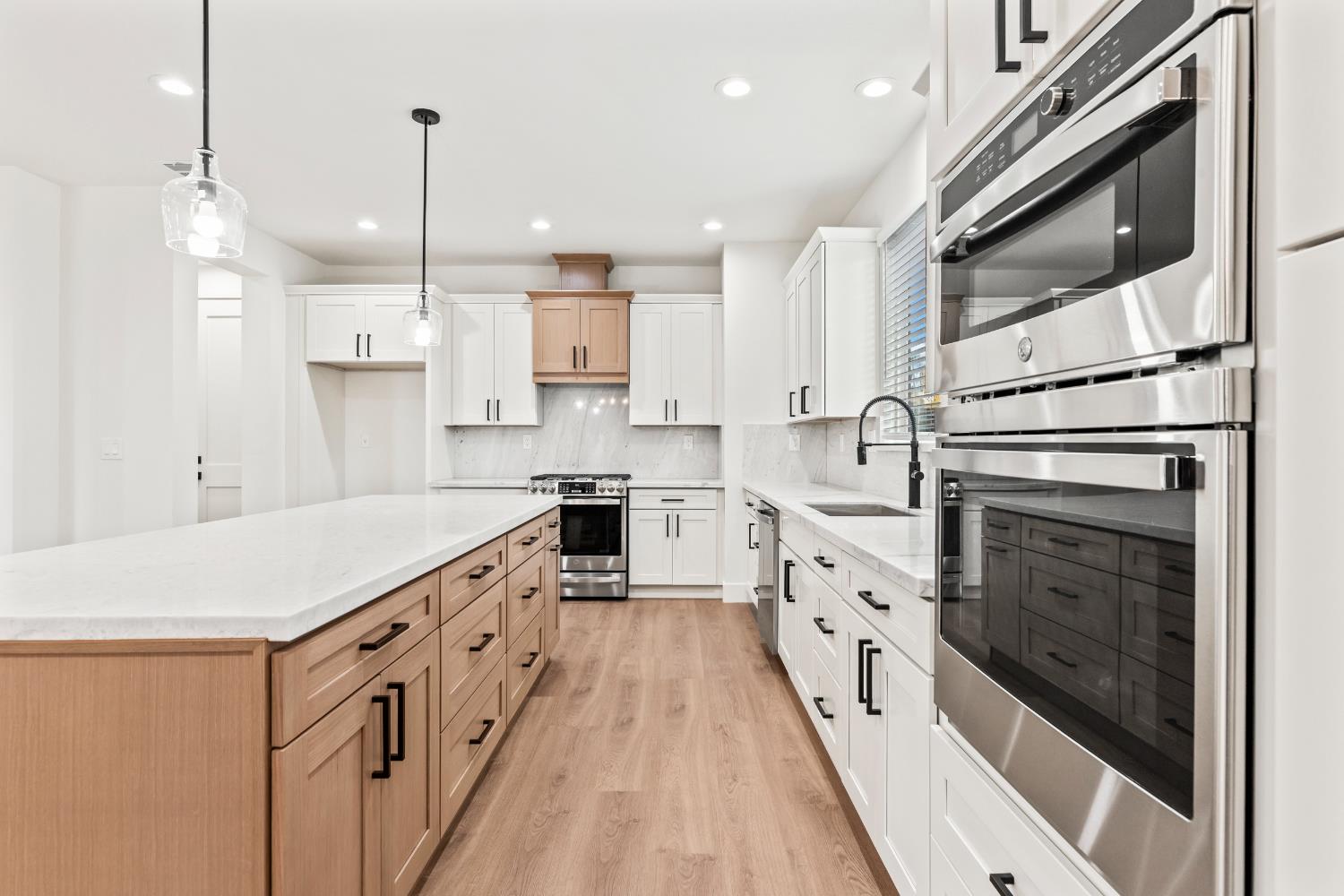 688 Cindy Drive Ripon, CA 95366 - Photo 13 of 57 a large kitchen with stainless steel appliances kitchen island granite countertop a stove a sink and a refrigerator