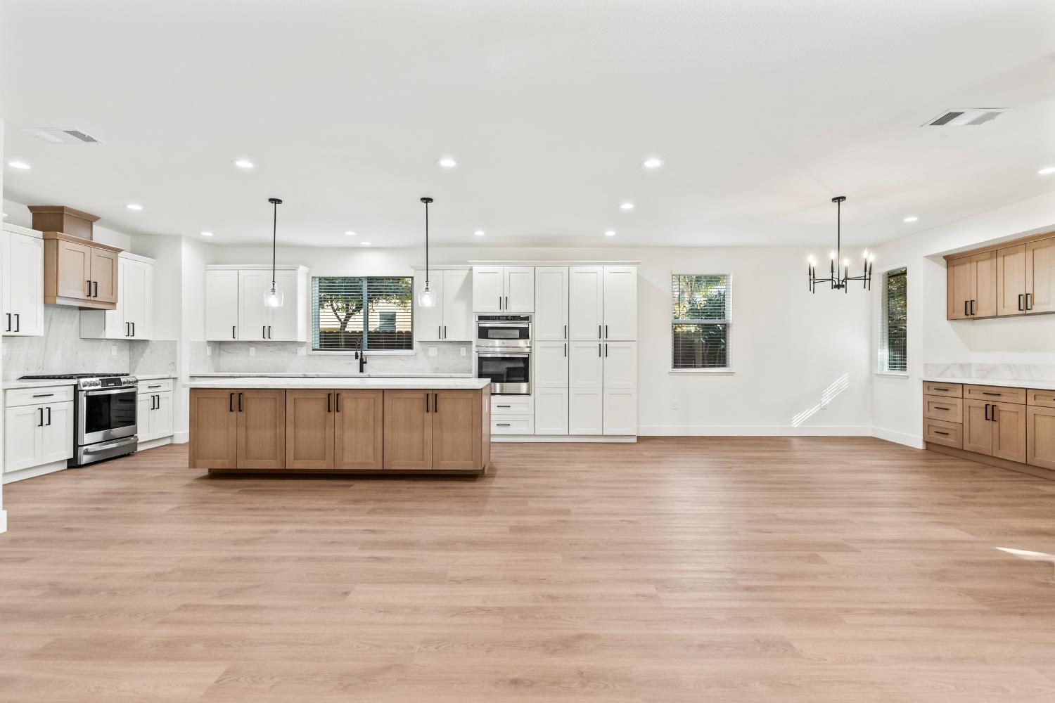 688 Cindy Drive Ripon, CA 95366 - Photo 15 of 57 a large kitchen with a large counter top a sink stainless steel appliances and cabinets