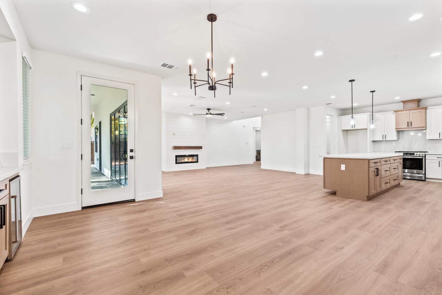 688 Cindy Drive Ripon, CA 95366 - Photo 16 of 57 a view of a kitchen with kitchen island stainless steel appliances wooden floor and living room view