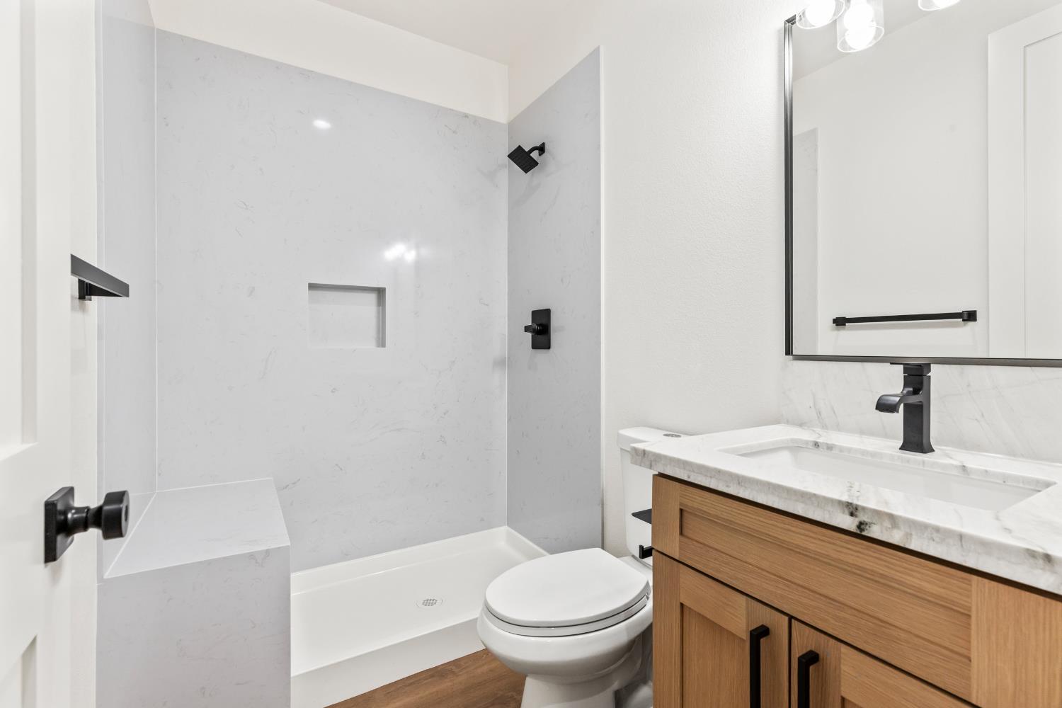 688 Cindy Drive Ripon, CA 95366 - Photo 19 of 57 a bathroom with a granite countertop sink toilet and shower