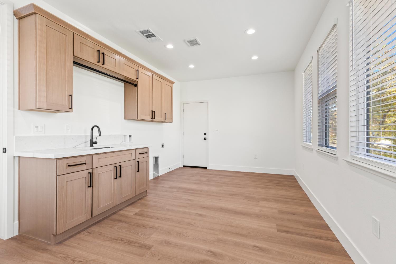 688 Cindy Drive Ripon, CA 95366 - Photo 20 of 57 a view of a kitchen with sink dishwasher and wooden floor