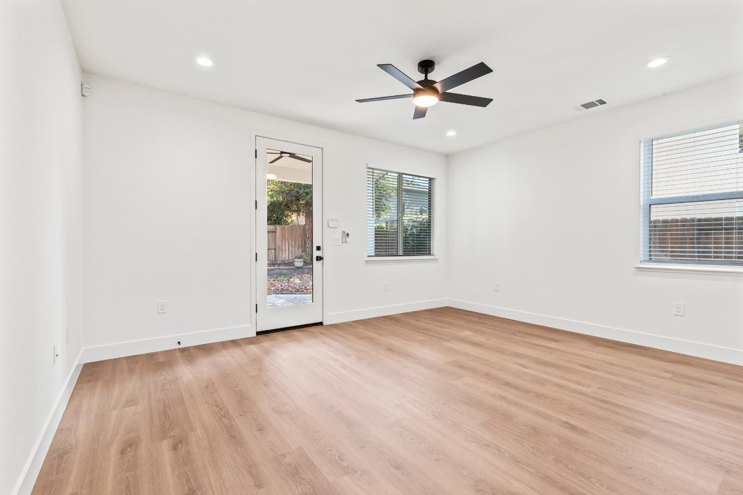 688 Cindy Drive Ripon, CA 95366 - Photo 22 of 57 a view of an empty room with a window and wooden floor