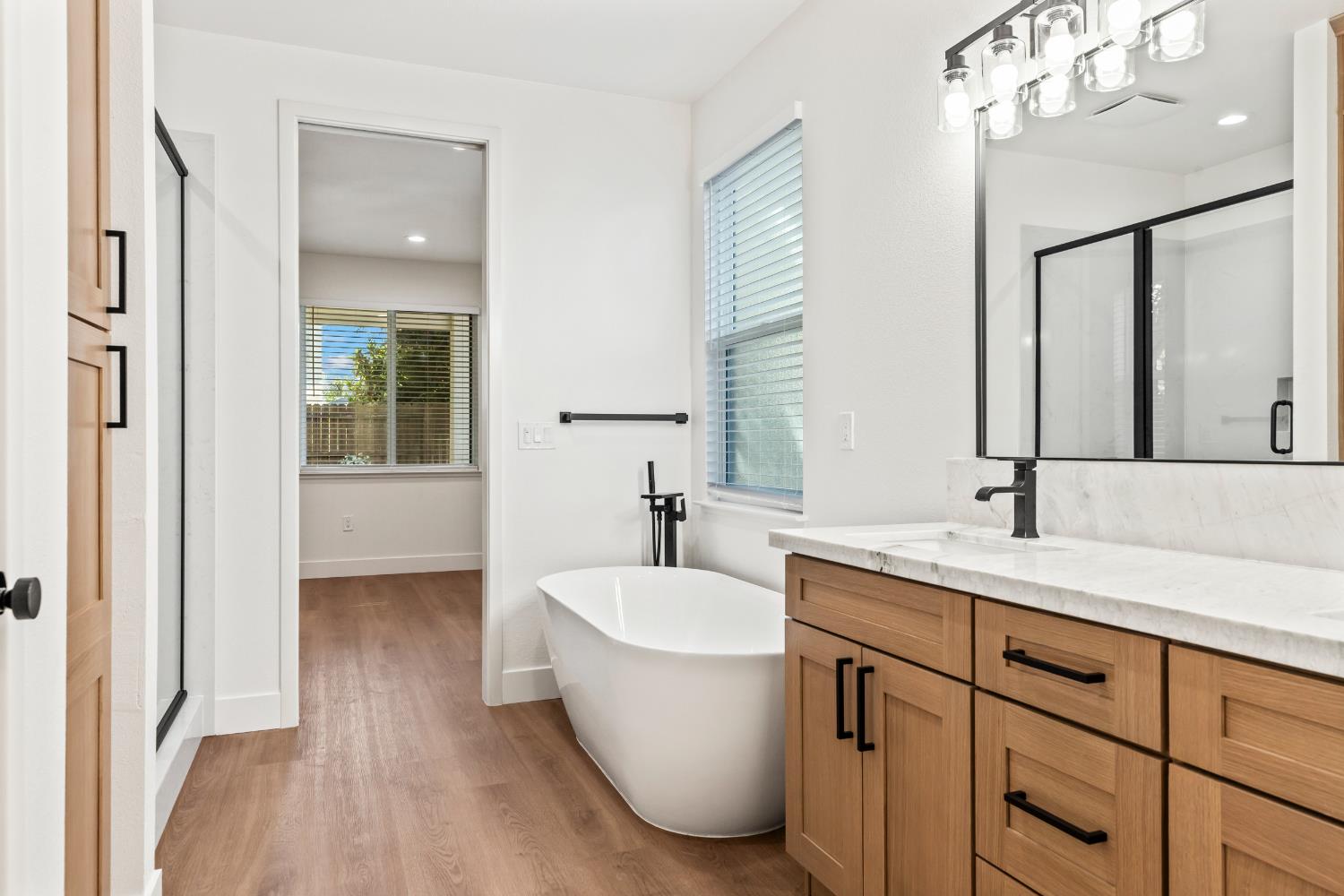 688 Cindy Drive Ripon, CA 95366 - Photo 26 of 57 a bathroom with a tub sink and mirror
